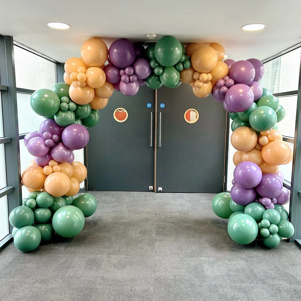 Colour-blocked balloon arch, organic in style.