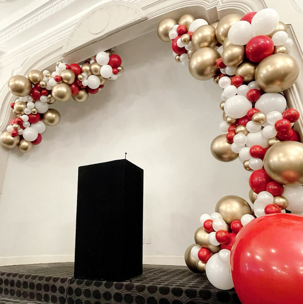 White, gold and red semi arch.