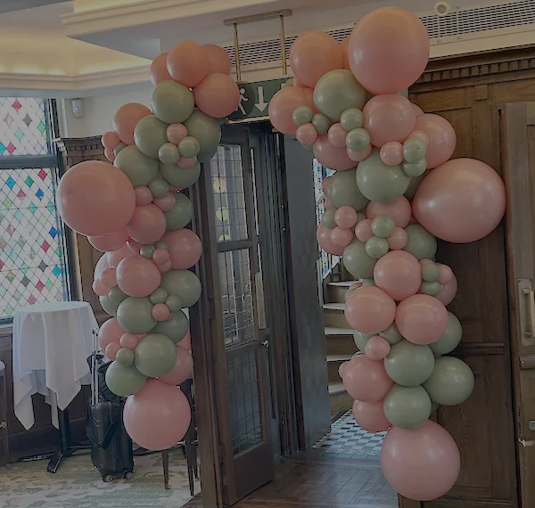 Pink and green balloon display installed for a private client at The Ivy in Covent Garden, designed to complement the restaurant’s vibrant interior aesthetic and create a standout focal point for the celebration.