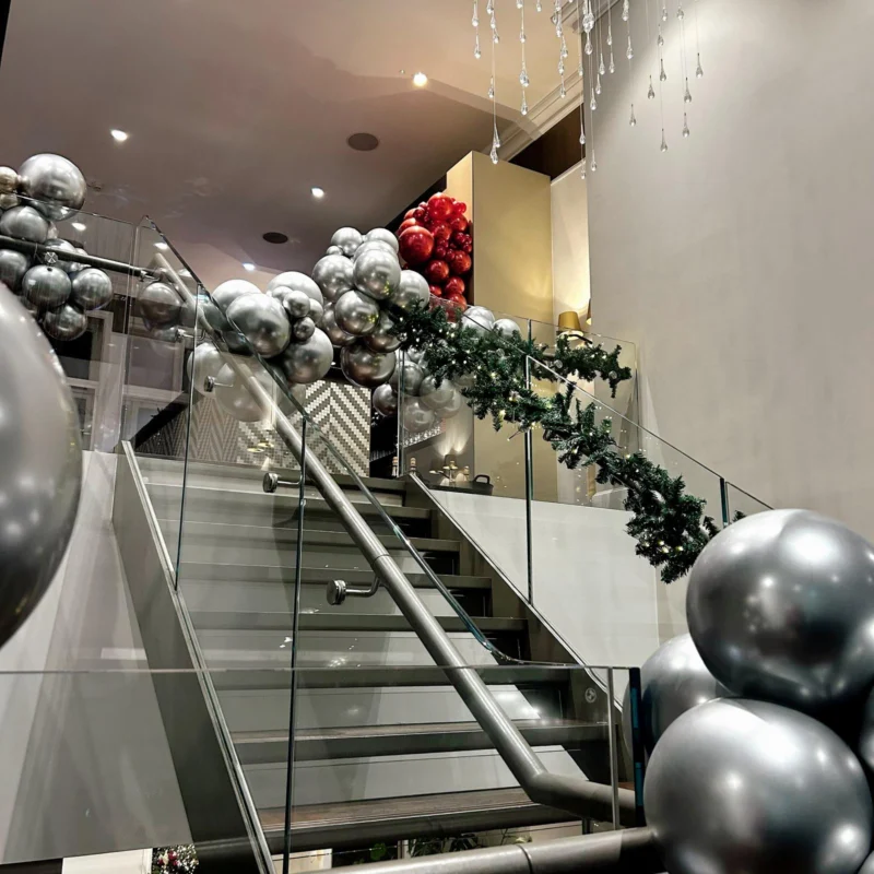 Silver balloon clusters decorating the Moët Hennessy staircase for Christmas