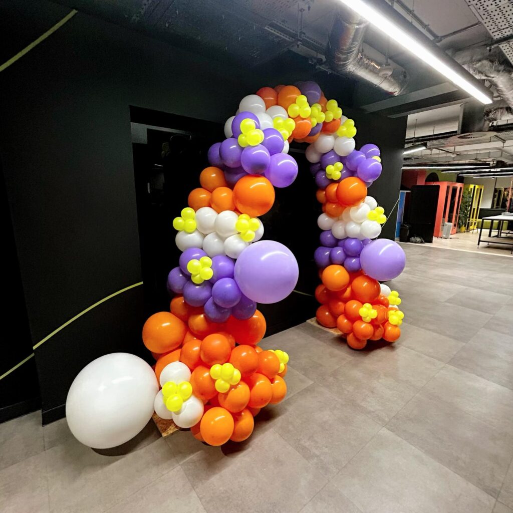 Orange, white, purple and lime balloon arch