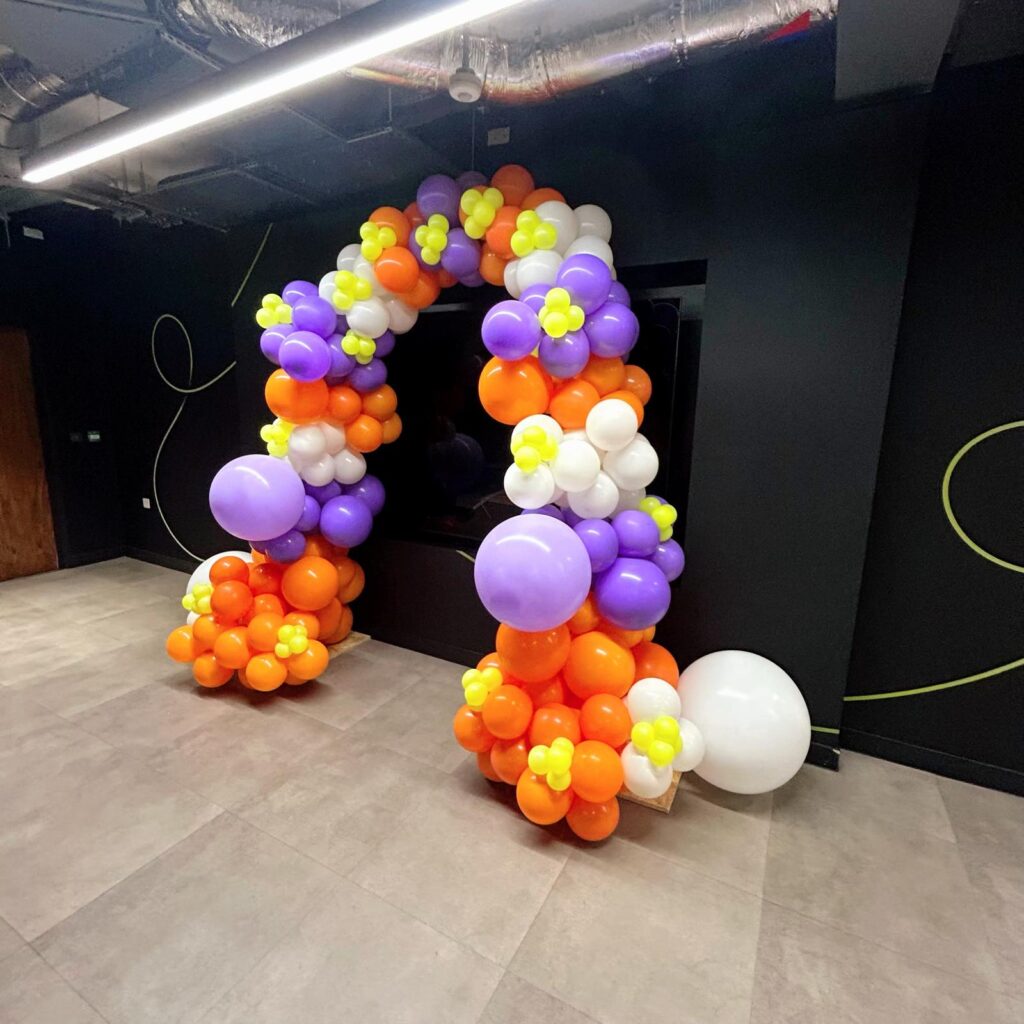 Orange, white, purple and lime balloon arch
